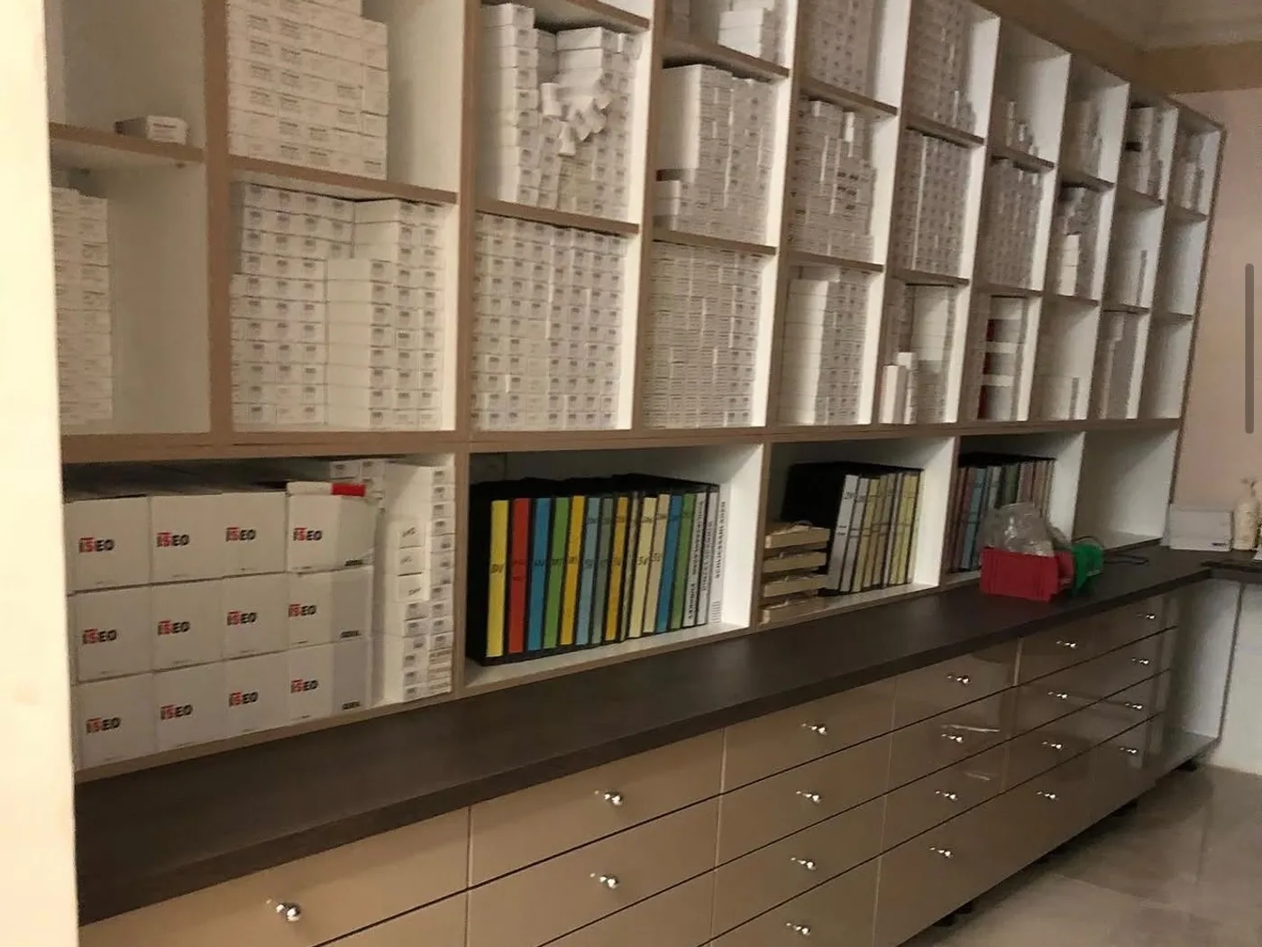 Open stock compartments above a continuous run of drawers