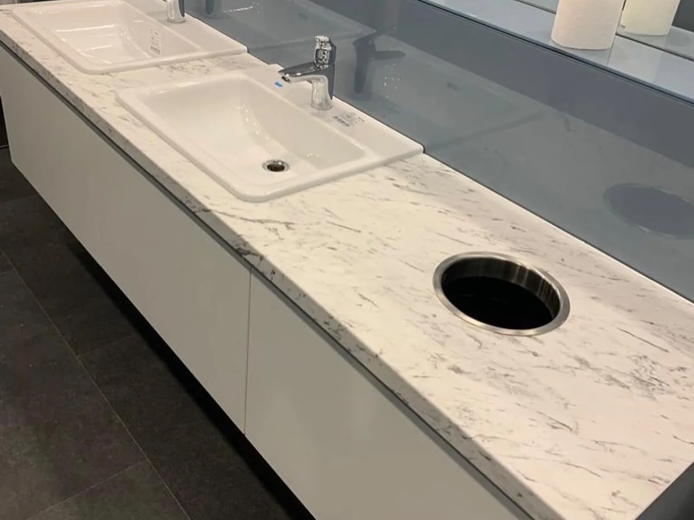 Double vanity unit with marble-finish top and glass splashback